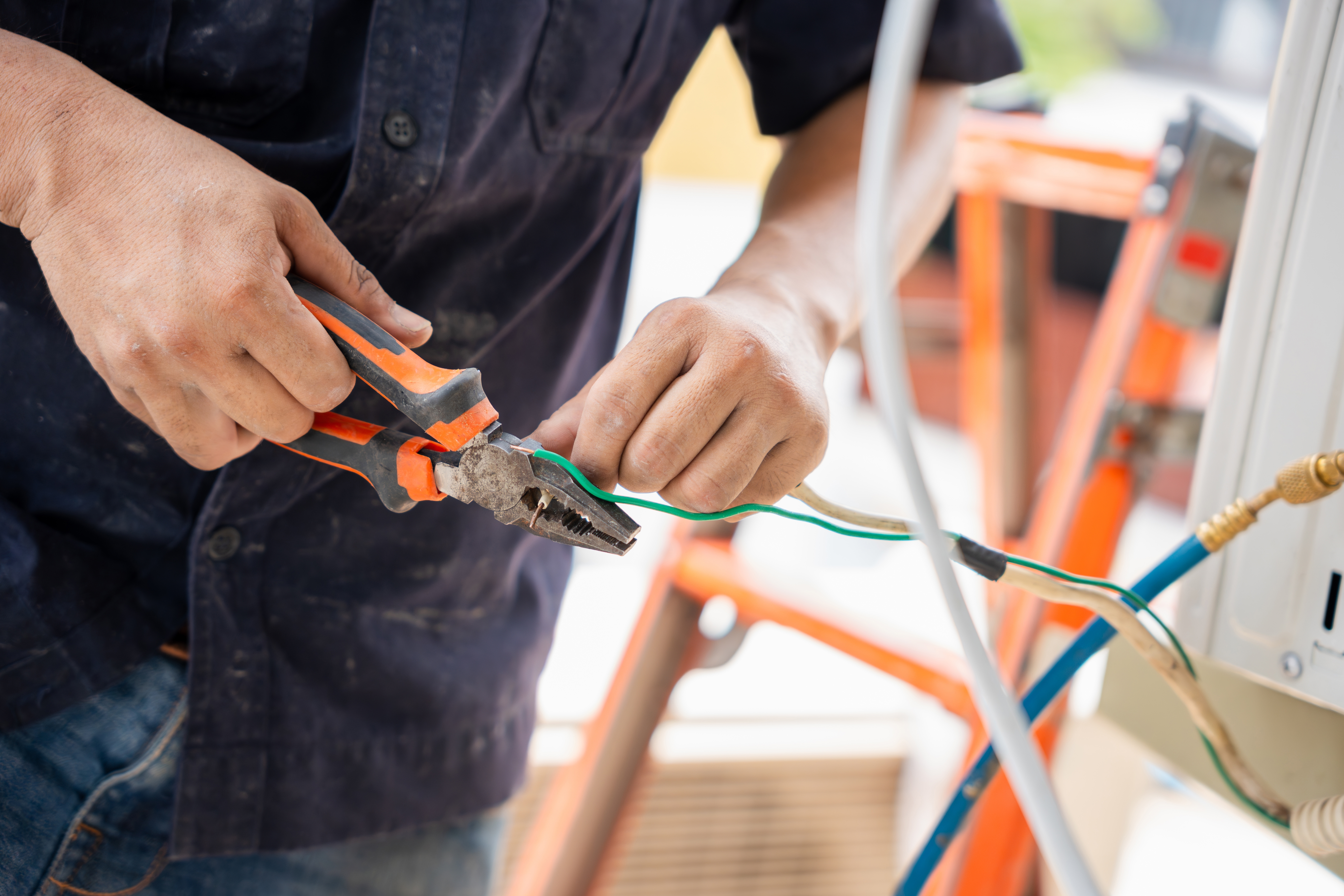 person cutting hvac wires
